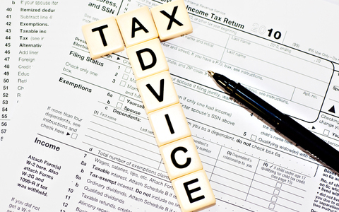 Tax Advice spelled in tiles over tax document